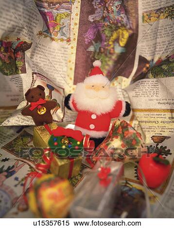 Stock Photography - Christmas ornaments on newspaper, high angle view. Fotosearch