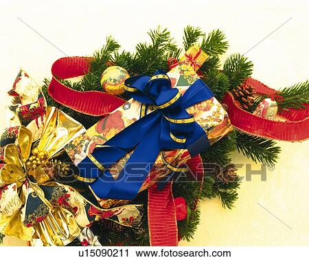 Stock Image - Christmas present on Christmas tree, high angle view. Fotosearch