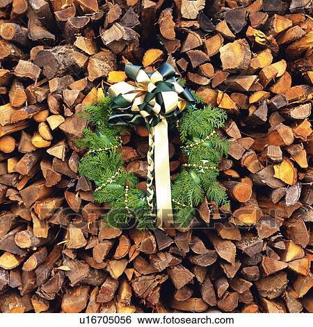 Christmas wreath on pile of wood sticks, front view View Large Photo Image Stock Photograph - Christmas wreath on pile of wood sticks, front view. Fotosearch