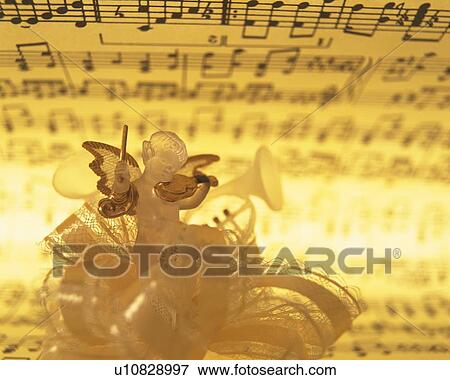 Glass angel playing violin and image of sheet music, front view View Large Photo Image Stock Photo - Glass angel playing violin and image of sheet music, front view. Fotosearch