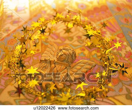 Gold Christmas wreath around angel ornament, high angle view View Large Photo Image Stock Photograph - Gold Christmas wreath around angel ornament, high angle view. Fotosearch