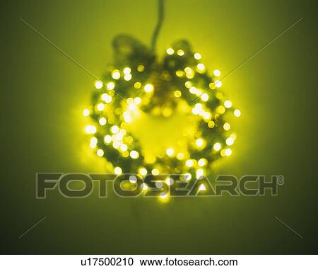 Stock Image - Illuminated Christmas wreath, front view, soft focus. Fotosearch