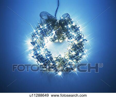 Stock Photo - Illuminated Christmas wreath, front view. Fotosearch