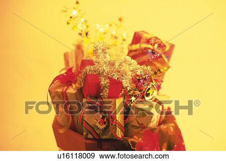 Pile of Christmas ornaments and presents, high angle view, toned image View Large Photo Image Stock Photo - Pile of Christmas ornaments and presents, high angle view, toned image. Fotosearch