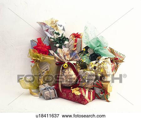 Stock Photo - Pile of Christmas presents, front view, white background. Fotosearch