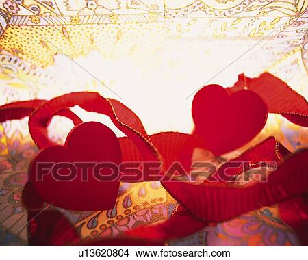 Picture - Red ribbons and heart shaped ornaments, close up. Fotosearch
