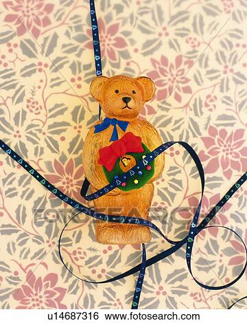 Ribbons around teddy bear holding Christmas wreath View Large Photo Image Stock Photograph - Ribbons around teddy bear holding Christmas wreath. Fotosearch