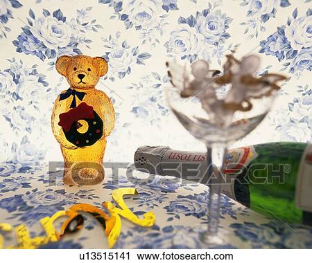 Teddy bear holding Christmas wreath and champagne bottle, front view View Large Photo Image Stock Image - Teddy bear holding Christmas wreath and champagne bottle, front view. Fotosearch