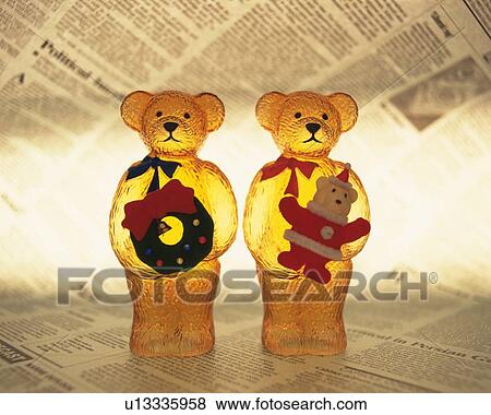 Two teddy bears standing on newspaper and holding bear Santa Claus and Christmas wreath, front view, composition View Large Photo Image Stock Photo - Two teddy bears standing on newspaper and holding bear Santa Claus and Christmas wreath, front view, composition. Fotosearch