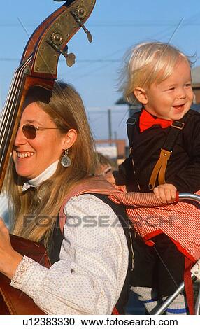 A mother playing the standup bass with her young son View Large Photo Image Stock Image - A mother playing the standup bass with her young son. Fotosearch