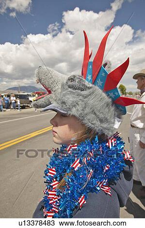 Stock Image - Child wearing unusual headgear for the Fourth of July Parade. Fotosearch
