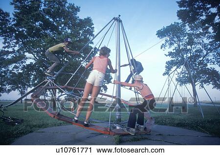 Stock Image - Children playing in a park. Fotosearch