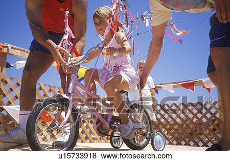 Girl on bicycle View Large Photo Image Stock Photo - Girl on bicycle. Fotosearch