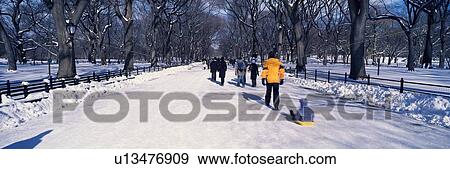 Panoramic view of walker pulling sled with child on fresh snow View Large Photo Image Stock Photo - Panoramic view of walker pulling sled with child on fresh snow. Fotosearch