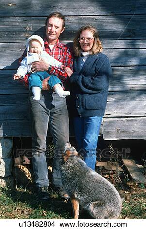 Parents and their baby on the family farm View Large Photo Image Picture - Parents and their baby on the family farm. Fotosearch