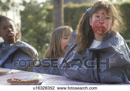 Stock Image - Teenagers in a pie eating contest. Fotosearch
