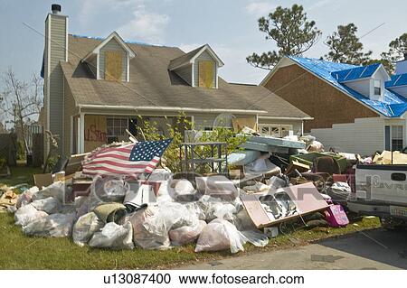 American flag and debris in front of house heavily hit by Hurricane Ivan View Large Photo Image Stock Image - American flag and debris in front of house heavily hit by Hurricane Ivan . Fotosearch