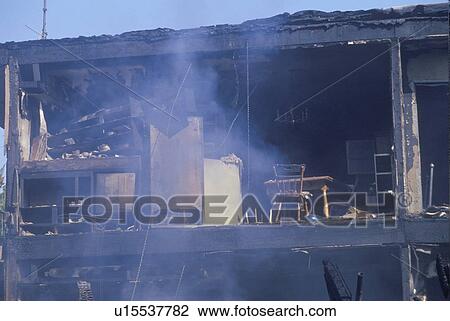 An apartment building on fire as a result of an earthquake View Large Photo Image Stock Image - An apartment building on fire as a result of an earthquake. Fotosearch