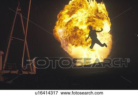 Man leaping through fireball View Large Photo Image Stock Photo - Man leaping through fireball. Fotosearch