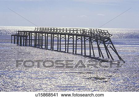 Stock Image - Pier at sunrise over the Gulf of Mexico. Fotosearch
