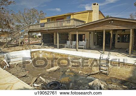 Swimming pool and debris in front of house heavily hit by Hurricane Ivan View Large Photo Image Stock Image - Swimming pool and debris in front of house heavily hit by Hurricane Ivan . Fotosearch