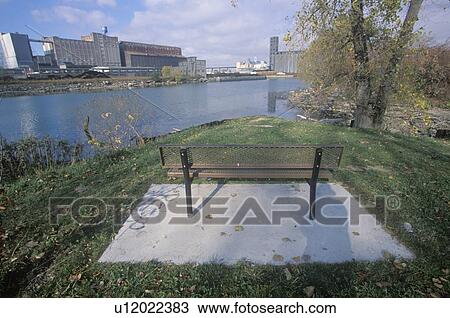 Stock Image - A bench overlooking an industrial park, USA. Fotosearch