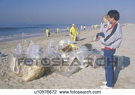 A man holding his child observing efforts to clean up an oil spill, USA View Large Photo Image Stock Image - A man holding his child observing efforts to clean up an oil spill, USA. Fotosearch