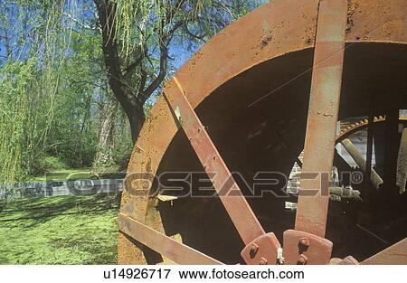 Stock Photo - An old brown water mill. Fotosearch