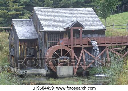 Stock Photo - An old brown water mill . Fotosearch