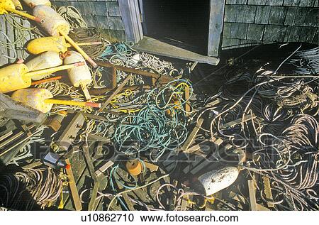 Stock Image - Ropes and buoys on dock. Fotosearch