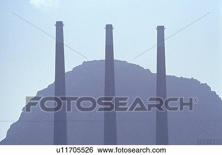 Three smoke stacks at a utility plant View Large Photo Image Stock Photograph - Three smoke stacks at a utility plant . Fotosearch