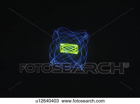 Stock Image - A glowing pattern of laser lights against a black background. Fotosearch