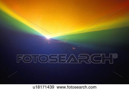 Stock Photo - A glowing rainbow pattern of laser lights against a black background. Fotosearch