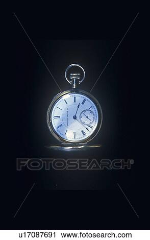 Stock Image - A pocketwatch against a black background. Fotosearch