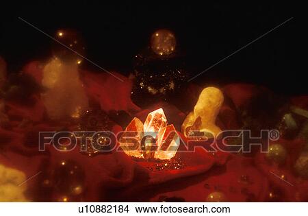 An assortment of precious jewels and glowing crystal rock formations on a ruby red cloth View Large Photo Image Picture - An assortment of precious jewels and glowing crystal rock formations on a ruby red cloth. Fotosearch