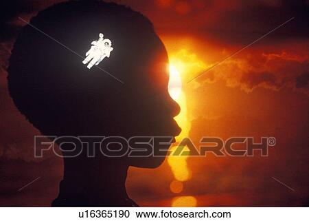 Stock Image - Silhouette of a child with space walking astronaut superimposed over his head. Fotosearch