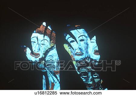 Stock Photography - Special effects composite of posterized silhouette of two hands and black sky. Fotosearch