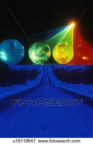 A blue and black horizon below several multi-colored spheres appearing as planets with laser lights shining through View Large Photo Image Stock Photo - A blue and black horizon below several multi-colored spheres appearing as planets with laser lights shining through. Fotosearch