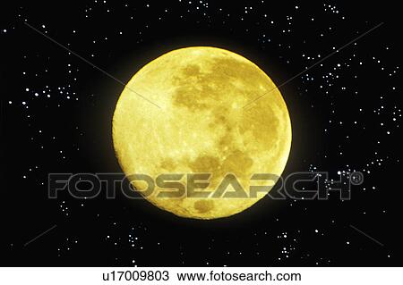 Stock Image - A close-up of a yellowish full moon in a starry sky. Fotosearch