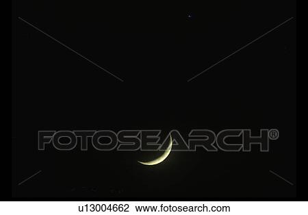 A crescent moon against a black starless sky View Large Photo Image Stock Image - A crescent moon against a black starless sky. Fotosearch