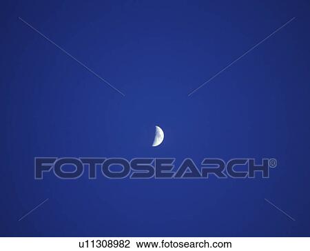 A crescent moon against a deep blue twilight sky View Large Photo Image Stock Image - A crescent moon against a deep blue twilight sky. Fotosearch