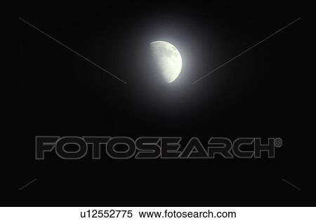 A crescent moon glowing through fog against a black starless sky View Large Photo Image Stock Photography - A crescent moon glowing through fog against a black starless sky. Fotosearch
