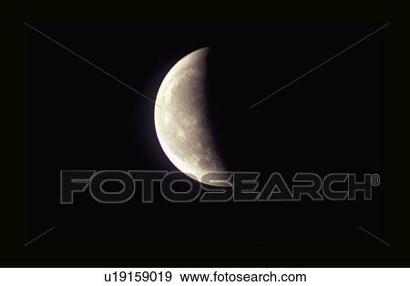 Stock Photo - A First Quarter moon against a black starless sky. Fotosearch