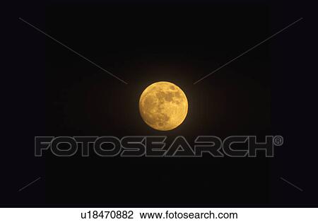 Stock Image - A full moon against a black starless sky. Fotosearch