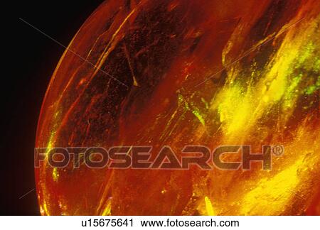 A glowing crystal sphere as orange laser light shines through View Large Photo Image Stock Image - A glowing crystal sphere as orange laser light shines through. Fotosearch