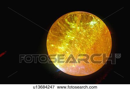 A glowing crystal sphere as orange laser light shines through View Large Photo Image Stock Photo - A glowing crystal sphere as orange laser light shines through. Fotosearch
