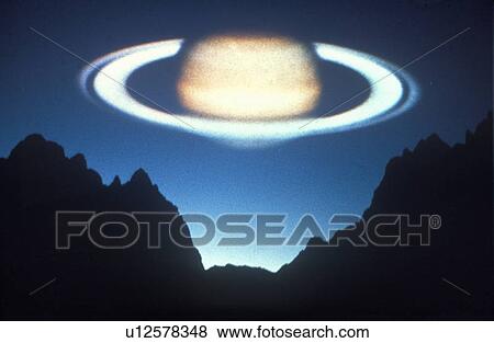 Stock Photo - Saturn superimposed on a blue sunset sky. Fotosearch