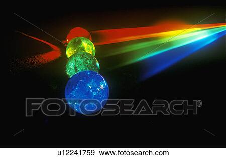 Several multi-colored spheres appearing as planets with laser lights shining through View Large Photo Image Stock Photo - Several multi-colored spheres appearing as planets with laser lights shining through. Fotosearch