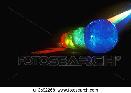 Several multi-colored spheres appearing as planets with laser lights shining through View Large Photo Image Stock Photo - Several multi-colored spheres appearing as planets with laser lights shining through. Fotosearch