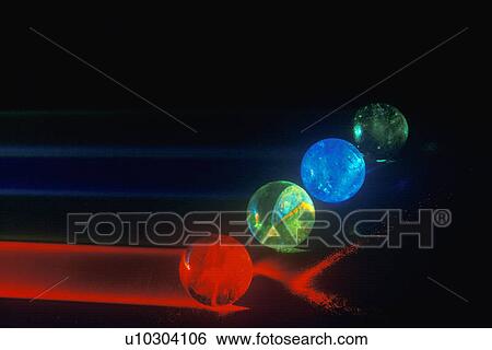 Several multi-colored spheres appearing as planets with laser lights shining through View Large Photo Image Stock Photograph - Several multi-colored spheres appearing as planets with laser lights shining through. Fotosearch